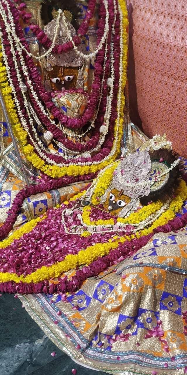 an elaborately decorated bed with flowers and beads