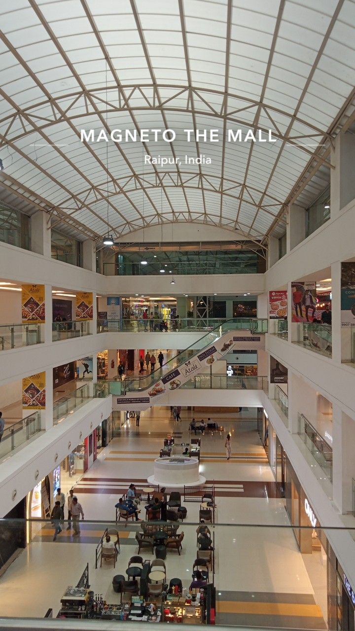 the inside of a shopping mall with people walking around