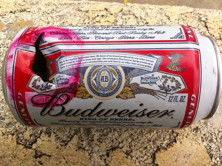 an open can of budweiser beer sitting on top of a granite counter