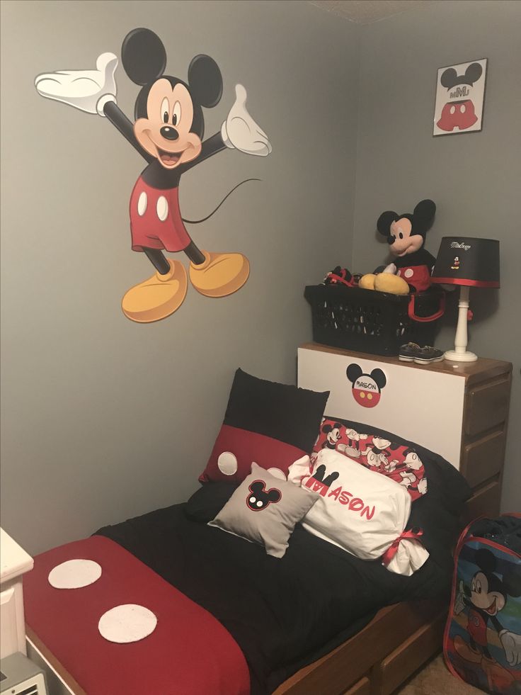 a bedroom with mickey mouse wall decals on the walls