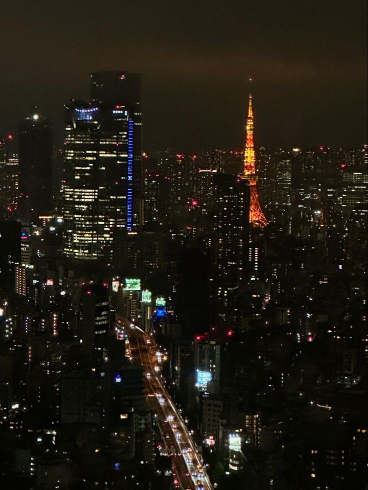 an aerial view of a city at night with the eiffel tower in the distance