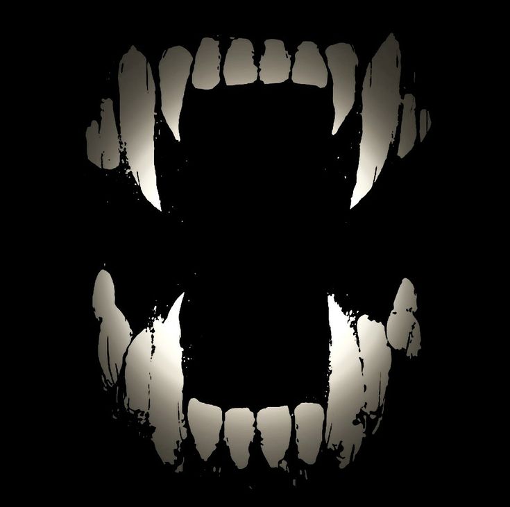 an abstract black and white photo of the mouth of a monster's teeth with light coming from behind it