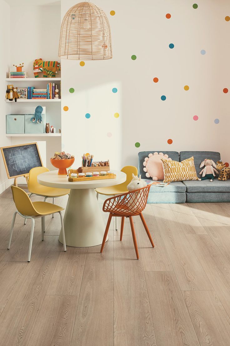 a living room filled with furniture and lots of polka dot wall decals on the walls