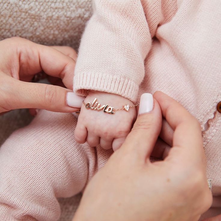 The You Have My Heart Script Name Bracelet was originally created to welcome Emily's beautiful baby girl, Olivia. Featuring your choice of 1-10 gold script letters and our signature heart motif with full-cut diamonds, this custom, one-of-a-kind bracelet comes in two sizes for either baby or mama. Personalized Dainty Yellow Gold Heart Bracelet, Personalized Yellow Gold Dainty Heart Bracelet, Adjustable Heart Bracelet With Name For Mother's Day, Personalized 14k Gold Heart Bracelet As A Gift, Personalized 14k Gold Heart Bracelet Gift, Baby Girl Bracelets Gold, Adjustable 14k Gold Name Bracelet For Mother's Day, Personalized 14k Gold Heart Bracelets, Personalized Yellow Gold Bracelet For Valentine's Day