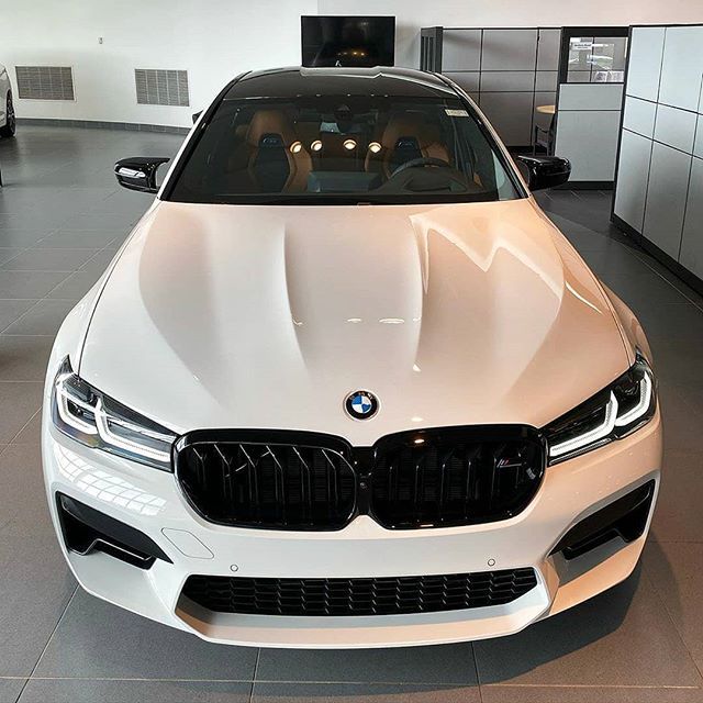 a white car is parked in a showroom