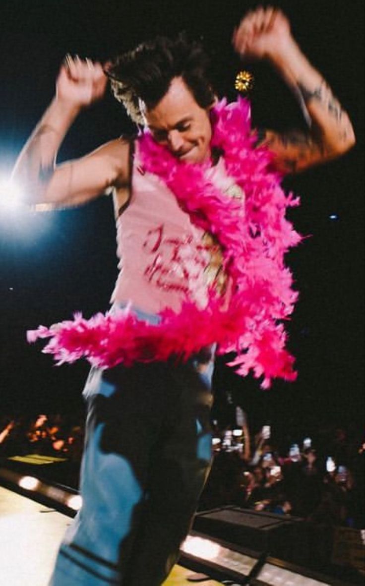 a man with pink feathers on his body