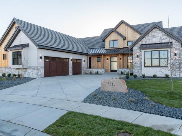 a large house with two garages in front of it