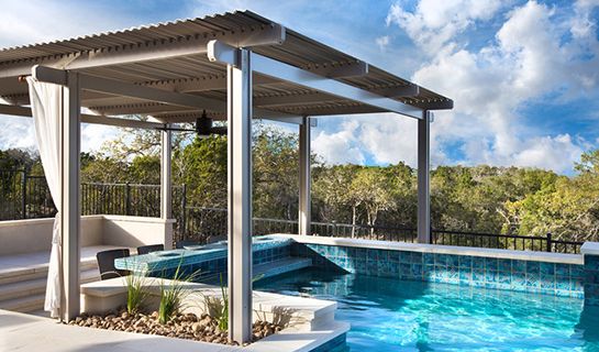 an outdoor swimming pool with a pergolated gazebo