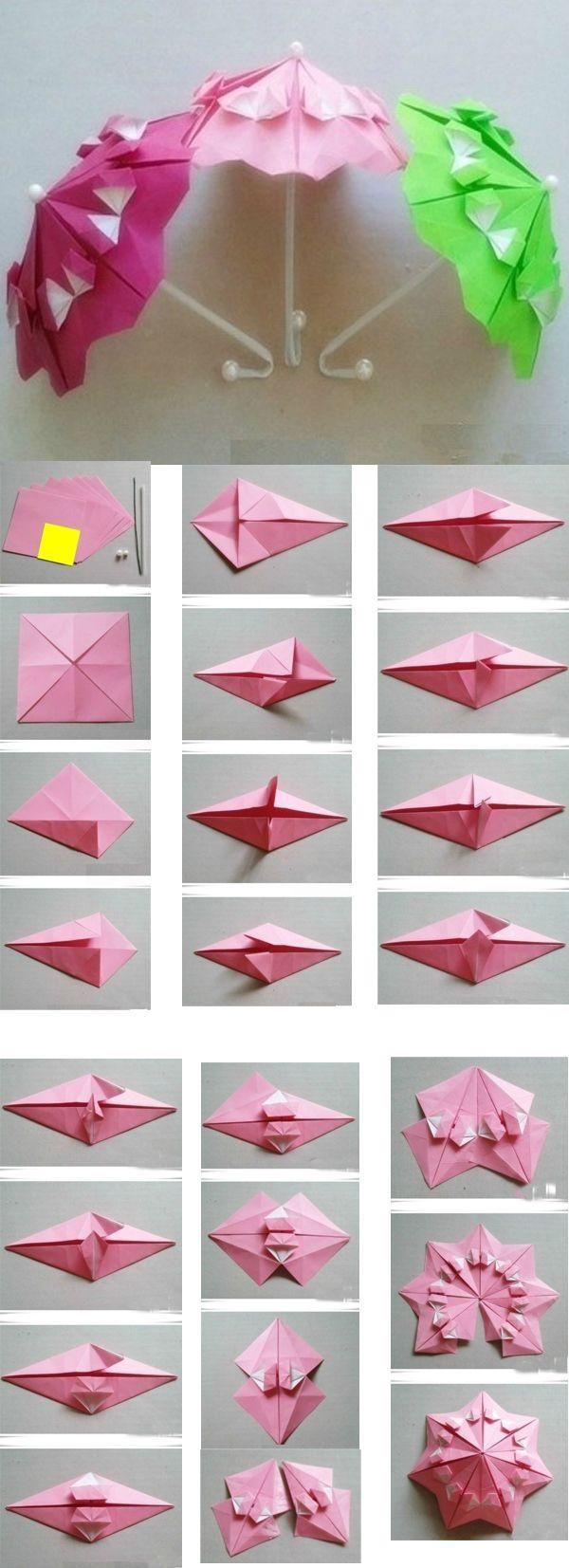 an origami umbrella made out of pink and green paper, with instructions to fold it