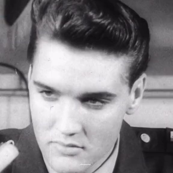 black and white photograph of a man in uniform looking at the camera with an angry look on his face