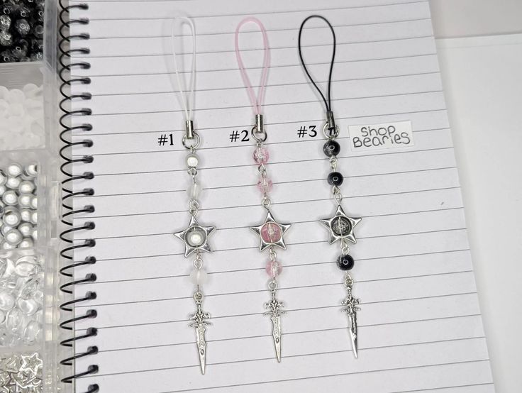 several different types of earrings are on a notepad