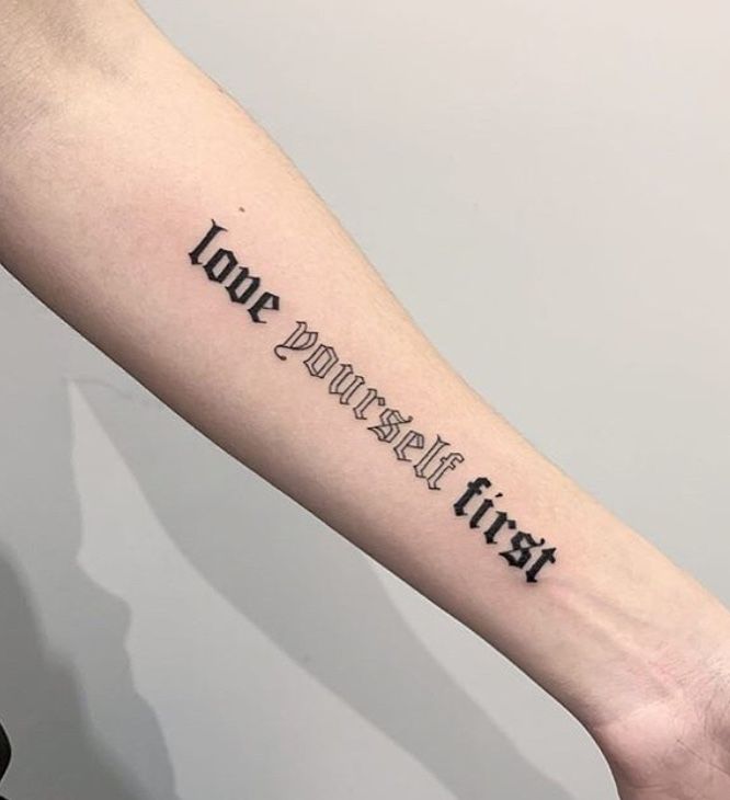 a person's arm with the words love yourself first on it, in black ink