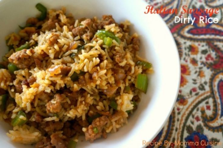 a white bowl filled with rice and meat on top of a colorful table cloth next to a rug