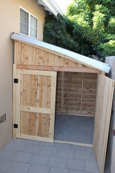 an outdoor storage shed built into the side of a house