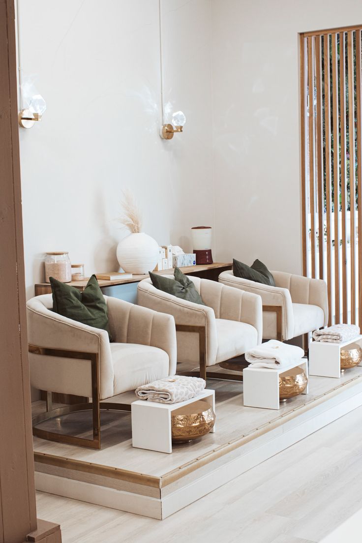 a living room filled with lots of white furniture