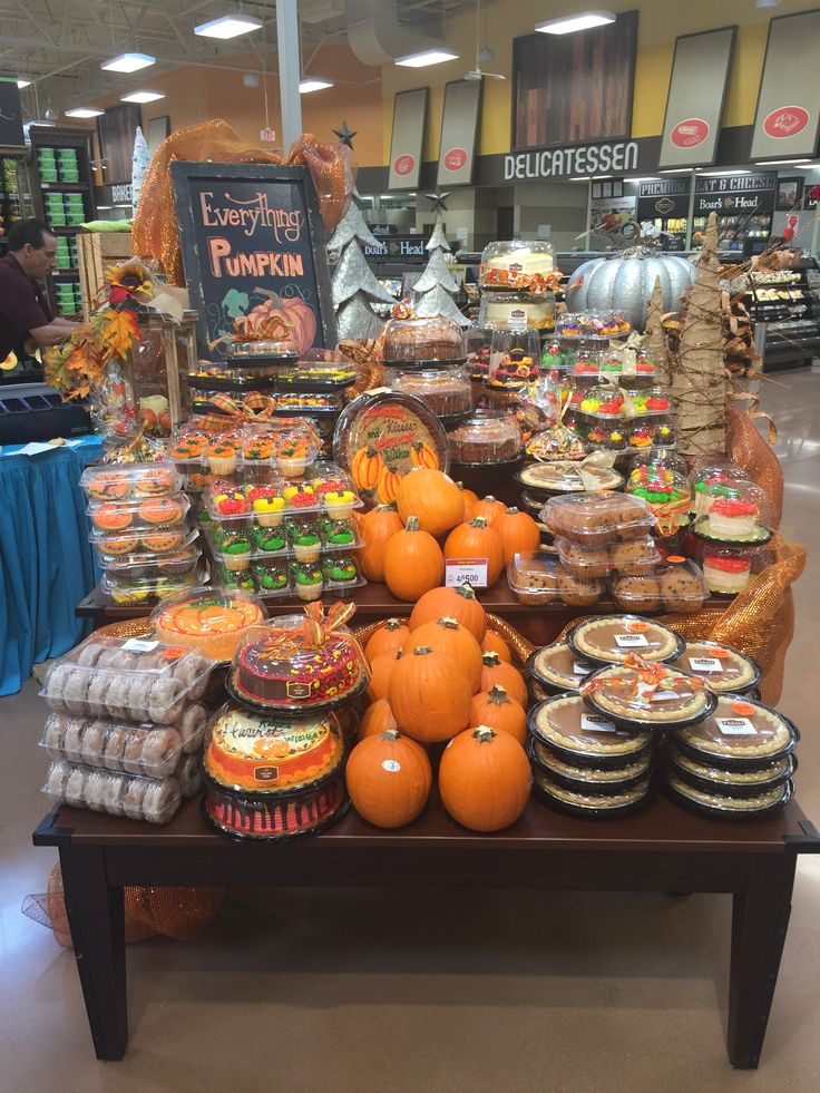 a display in a grocery store filled with lots of pumpkins and other food items