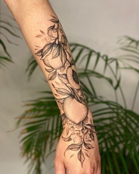 a person's arm with flowers on it and a hand holding something in the air