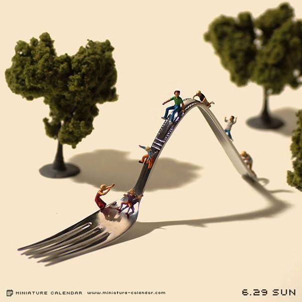 miniature people are riding on a fork that is stuck in the middle of two trees