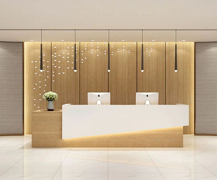 the front desk of a fashion store with lights hanging from it's walls and flowers in vases