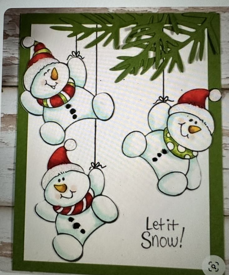 two snowmen hanging from a christmas tree with the words let it snow on them