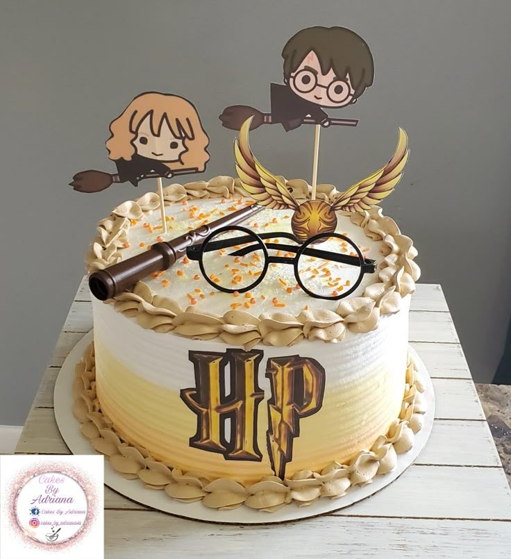 a harry potter birthday cake with glasses and wands