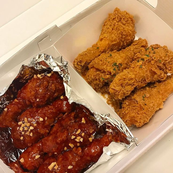 chicken wings and other food items in a box