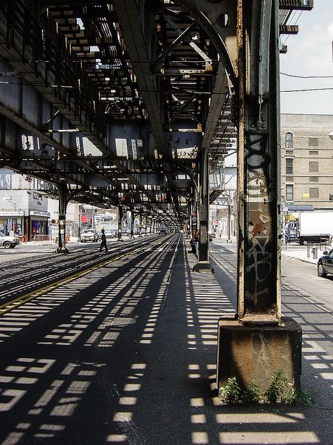 an empty train station with lots of tracks and graffiti on the wall next to it