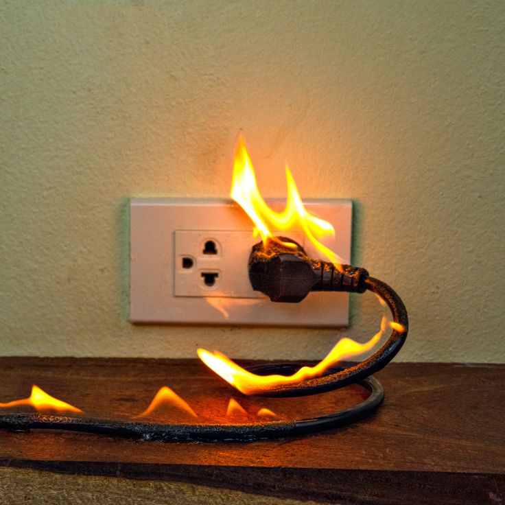 a light switch that has some kind of fire coming out of it's outlet