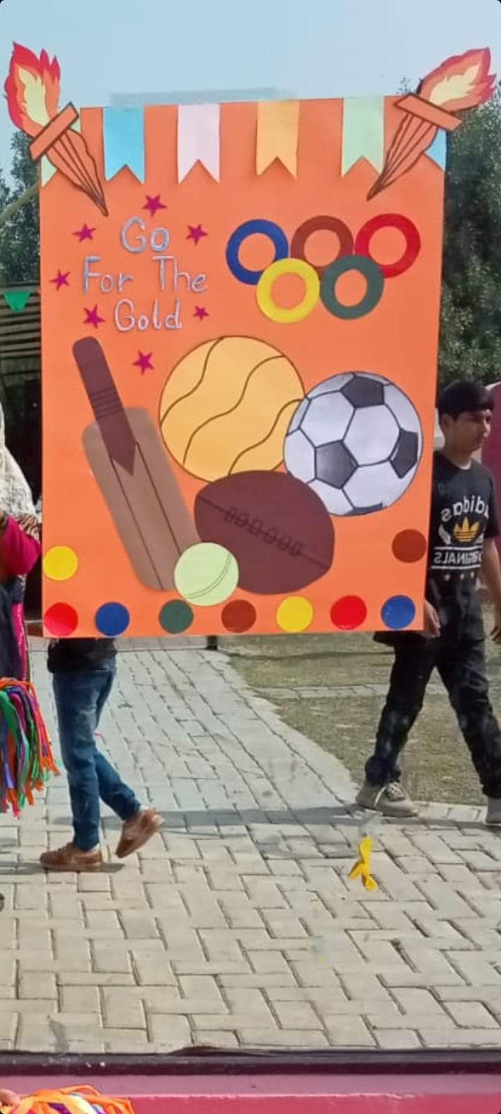 children are walking in front of a sign with soccer balls and tassels on it