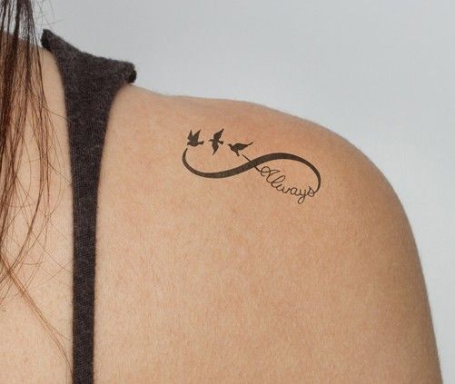 the back of a woman's shoulder with a tattoo on it that says love