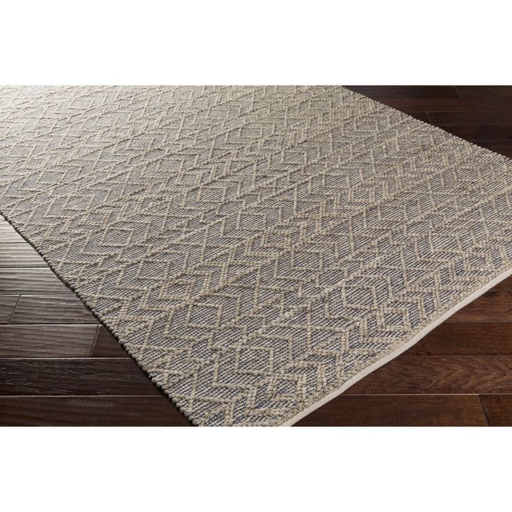 a white rug on top of a wooden floor