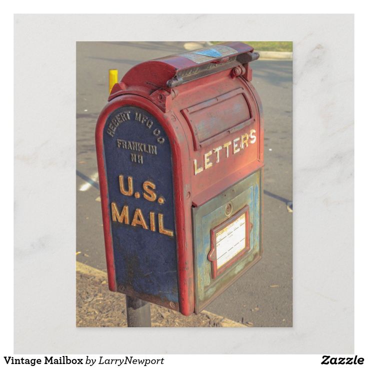 a red mailbox with the letter u s mail on it's side next to a street