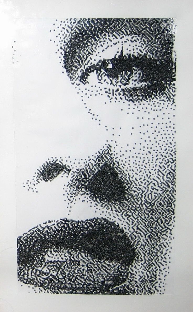 a black and white photo of a man's face made out of small dots