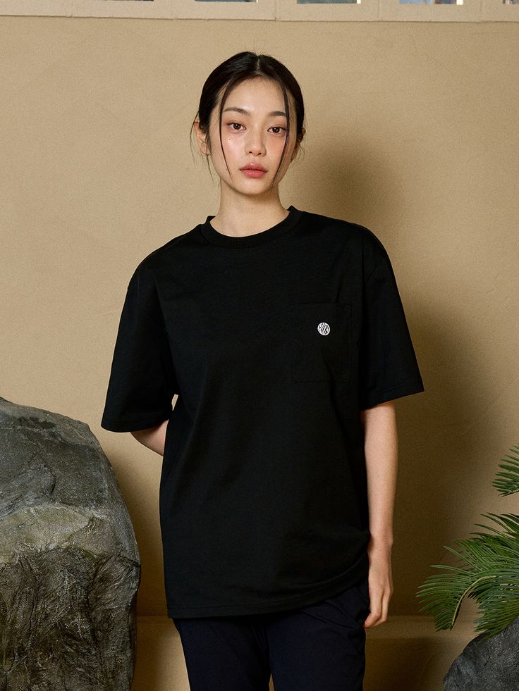 Editor's notesIt is a short sleeves shirt in ‘Aerosilver’ which is a breathable and anti-bacterial functional fiber. The oversized fit makes comfy relaxed silhouette. The design is basic and simple with a pocket and symbol embroidery. It is a good match with any items.- Oversized fit- Bias tape on neck- Pocket on the front- Logo symbol print- Logo label tapMeasurements(in.)M / L / XL- Length: 28.1 in. / 28.9 in. / 29.5 in.- Shoulder: 19.9 in. / 20.5 in. / 21.1 in.- Chest: 21.5 in. / 22.4 in. / 23.4 in.- Sleeve Length: 9.3 in. / 9.6 in. / 10 in.*Model info- Height 6’ 1” Weight 149.9 lbs / Fitting size: Size XL- Height 5’ 6” Weight 105.8 lbs / Fitting size: Size MComposition & Care- 65% Cotton, 35% Polyester- Hand wash recommended- Avoid tumble dryDesigner- by OFFGRID Sporty Short Sleeve Tops With Pockets, Basic Short Sleeve Tops With Side Pockets, Sporty Short Sleeve Tops With Side Pockets, Black Casual T-shirt With Logo, Oversized T-shirt With Pockets For Everyday Wear, Short Sleeve T-shirt With Pockets, Oversized T-shirt With Side Pockets, Solid Color T-shirt With Side Pockets, Lower T Shirt