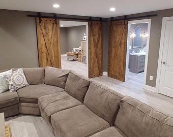 a large sectional couch sitting in the middle of a living room next to a doorway