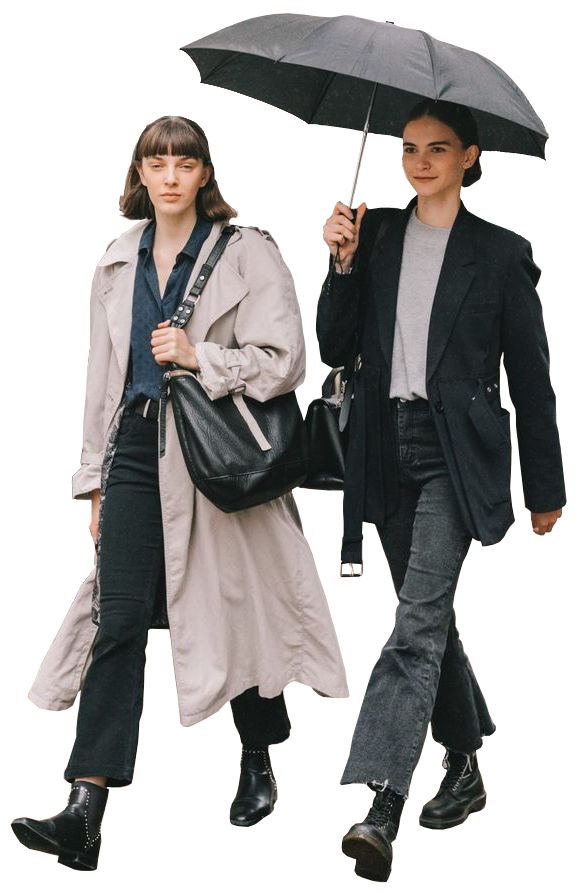 two people walking down the street with umbrellas over their heads and one holding a handbag