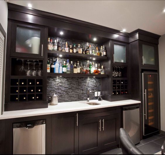 a home bar with wine bottles on the shelves