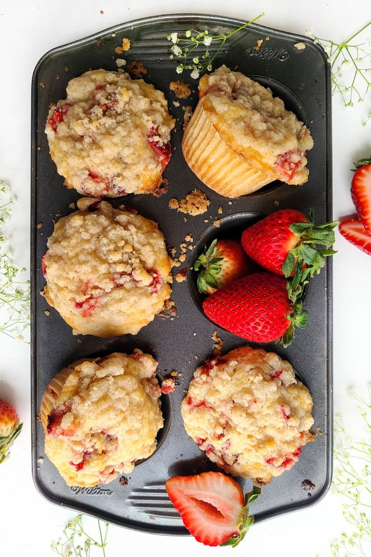 strawberry muffins and strawberries on a baking tray