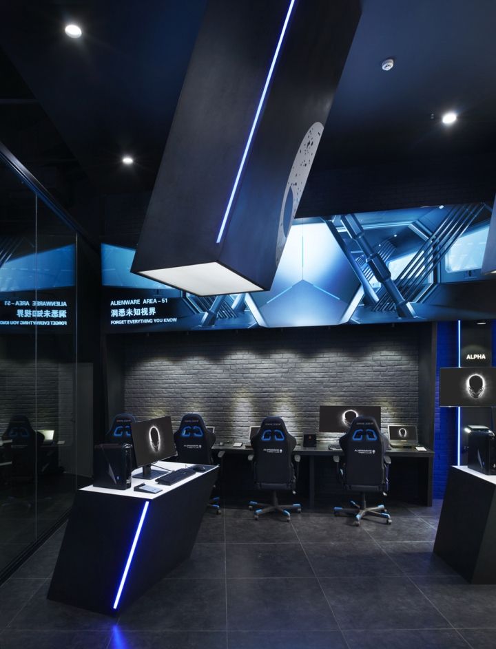 an office with black and blue lighting in the ceiling is pictured at this time of day