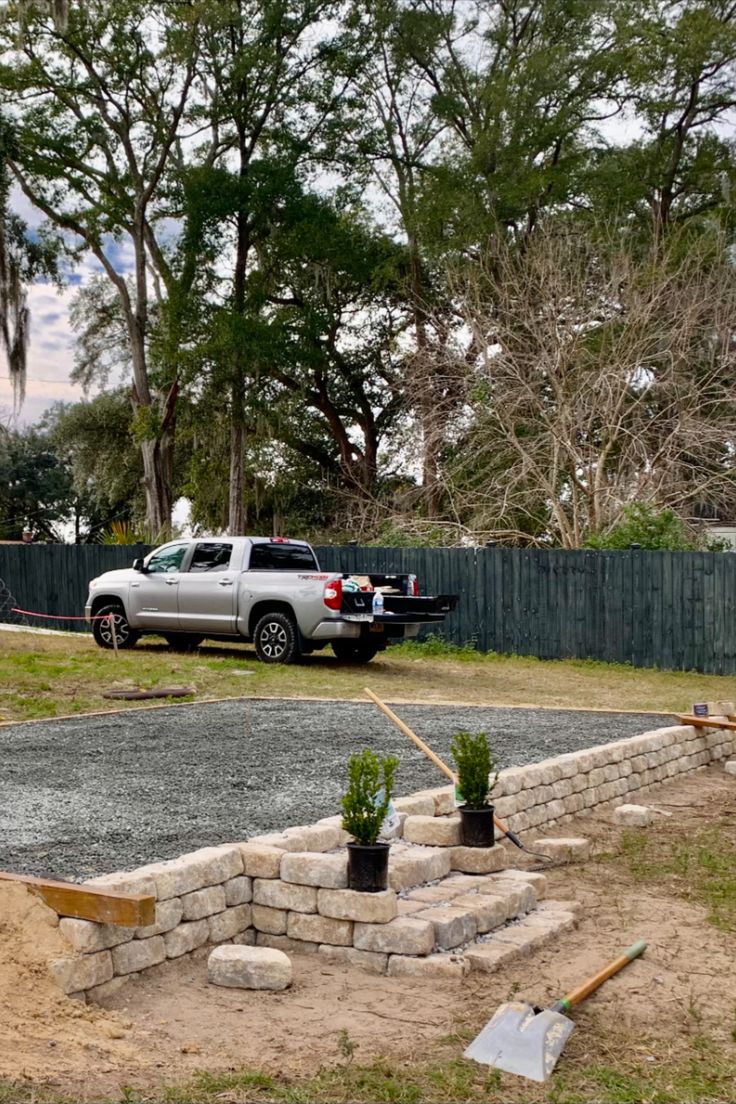 a truck parked in front of a house with landscaping equipment on the side of it