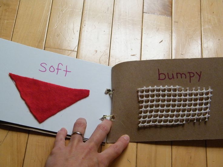 a hand is pointing at a piece of fabric on top of a book that says soft and bump