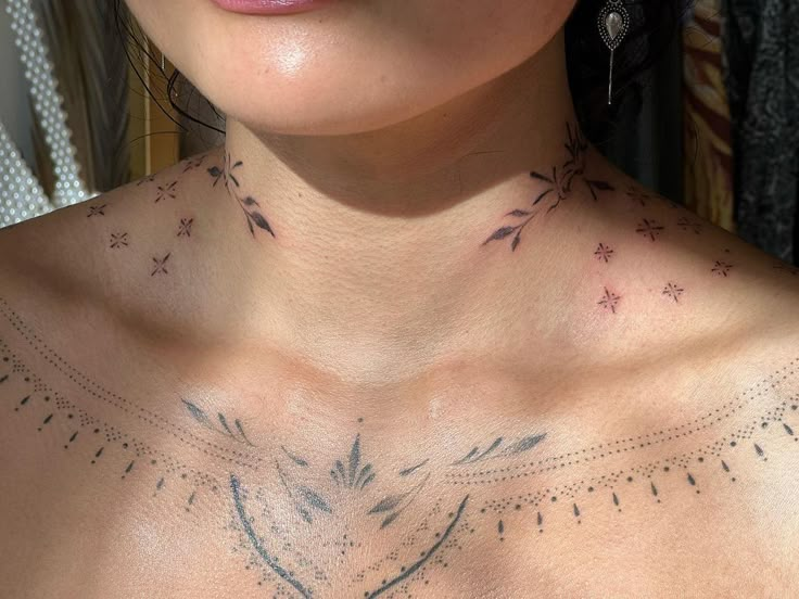 a woman with tattoos on her chest looking at the camera