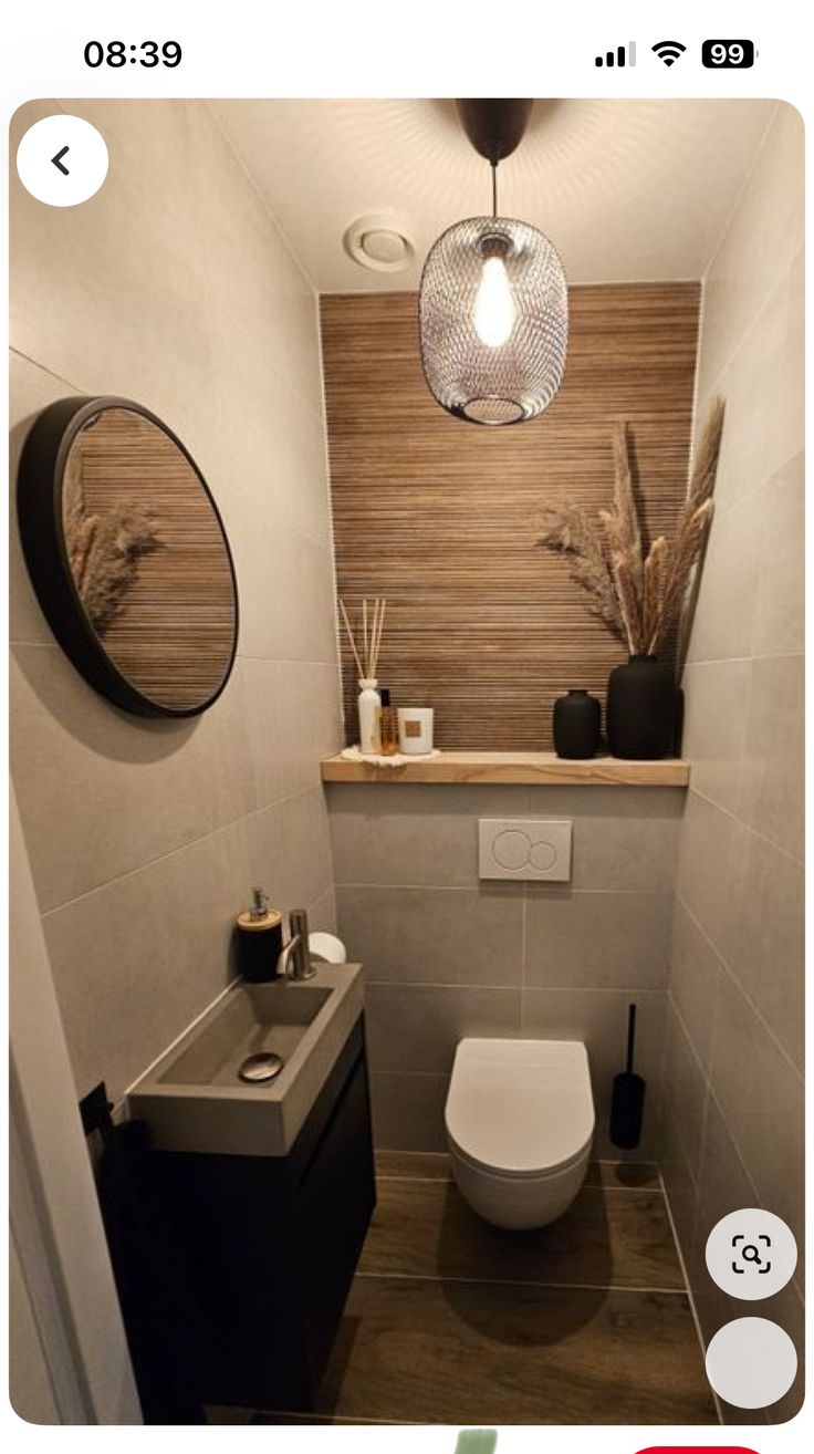 a bathroom with a toilet, sink and mirror on the wall next to each other