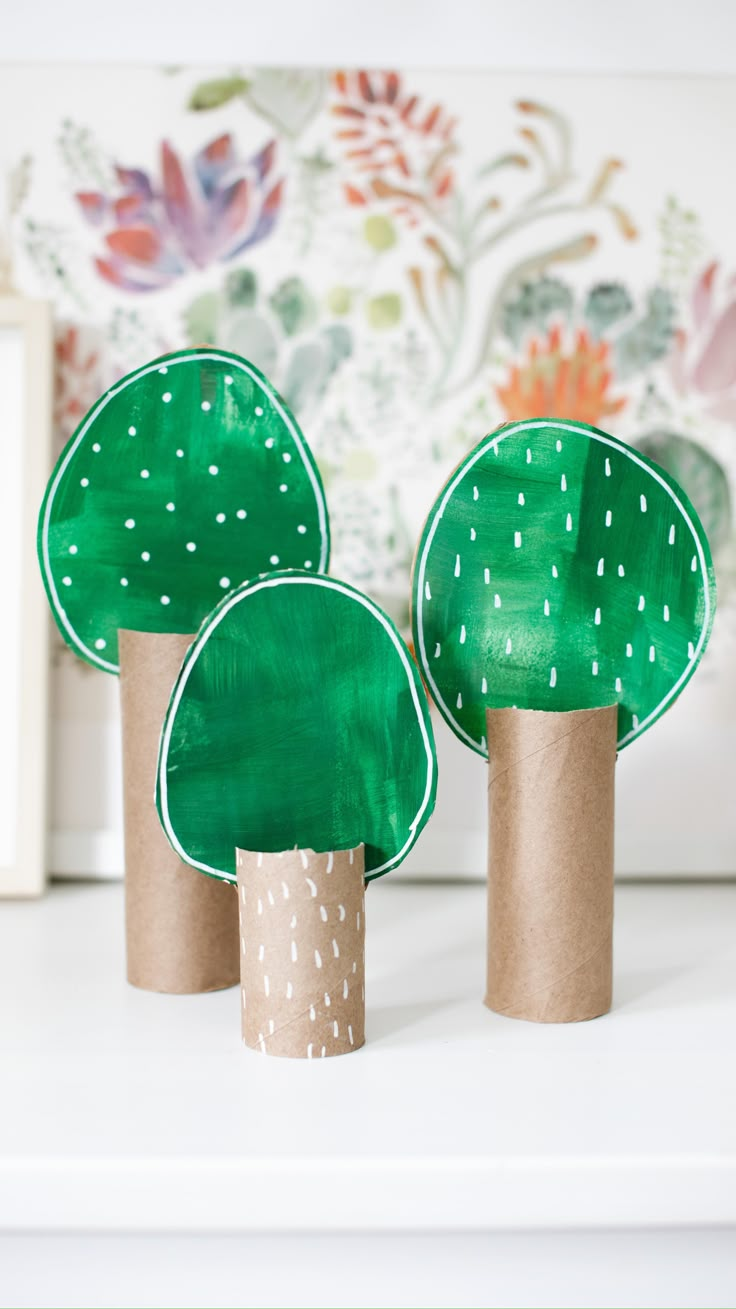 three green trees made out of toilet paper