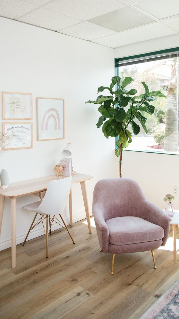 a living room with a chair, table and potted plant