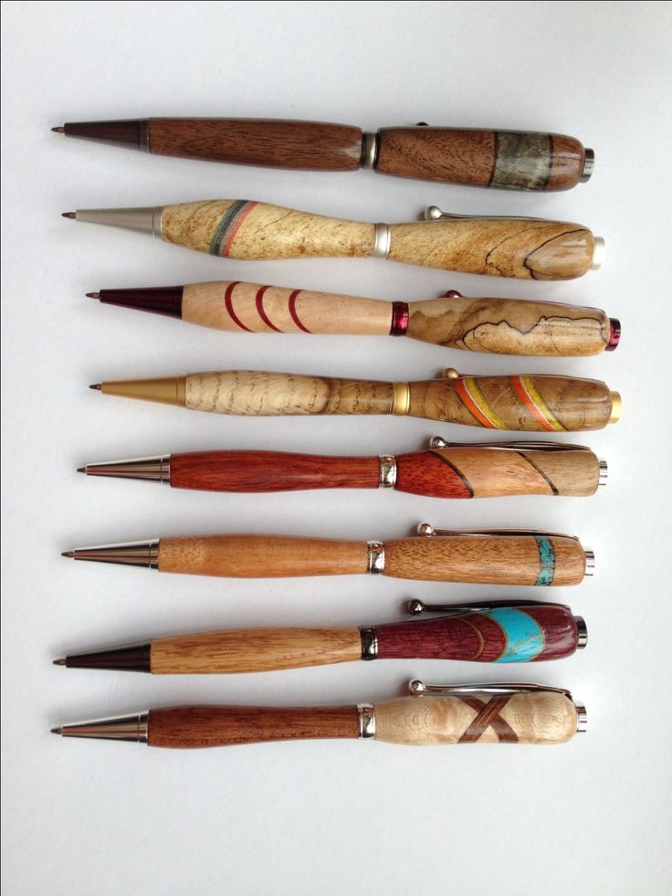 seven wooden pens lined up in a row