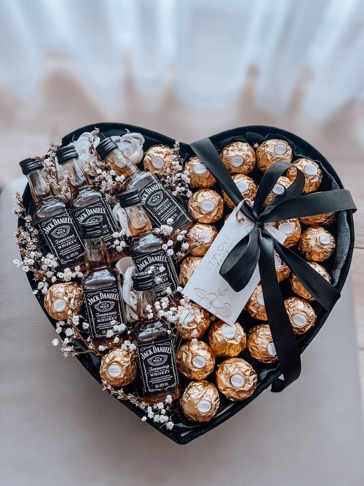 a heart shaped box filled with chocolates and candies on top of a table