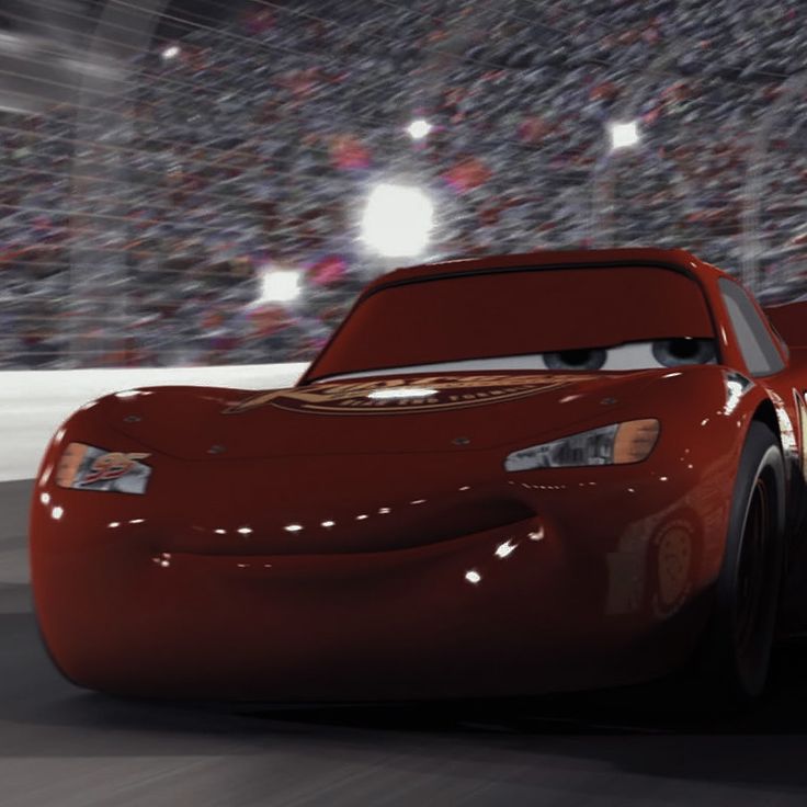 the character cars are driving in front of an audience