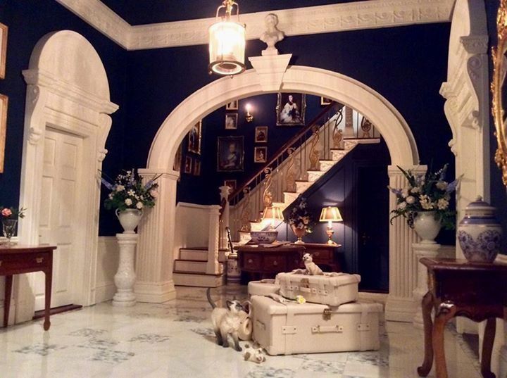 a living room filled with furniture and a staircase leading up to the second floor area