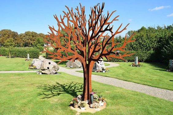 a large metal tree sitting in the middle of a park